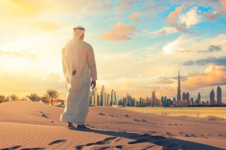 Arab,Man,Standing,Front,Dubai,Skyline,In,The,Desert,Of